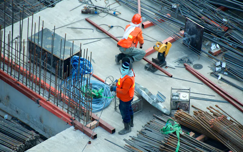 Construction workers placing reinforcement on a slab