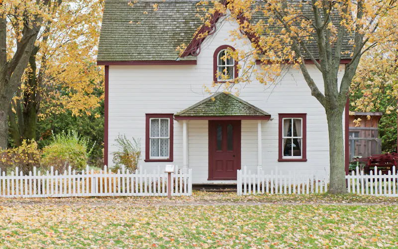 Classic weatherboard home with white picket fence