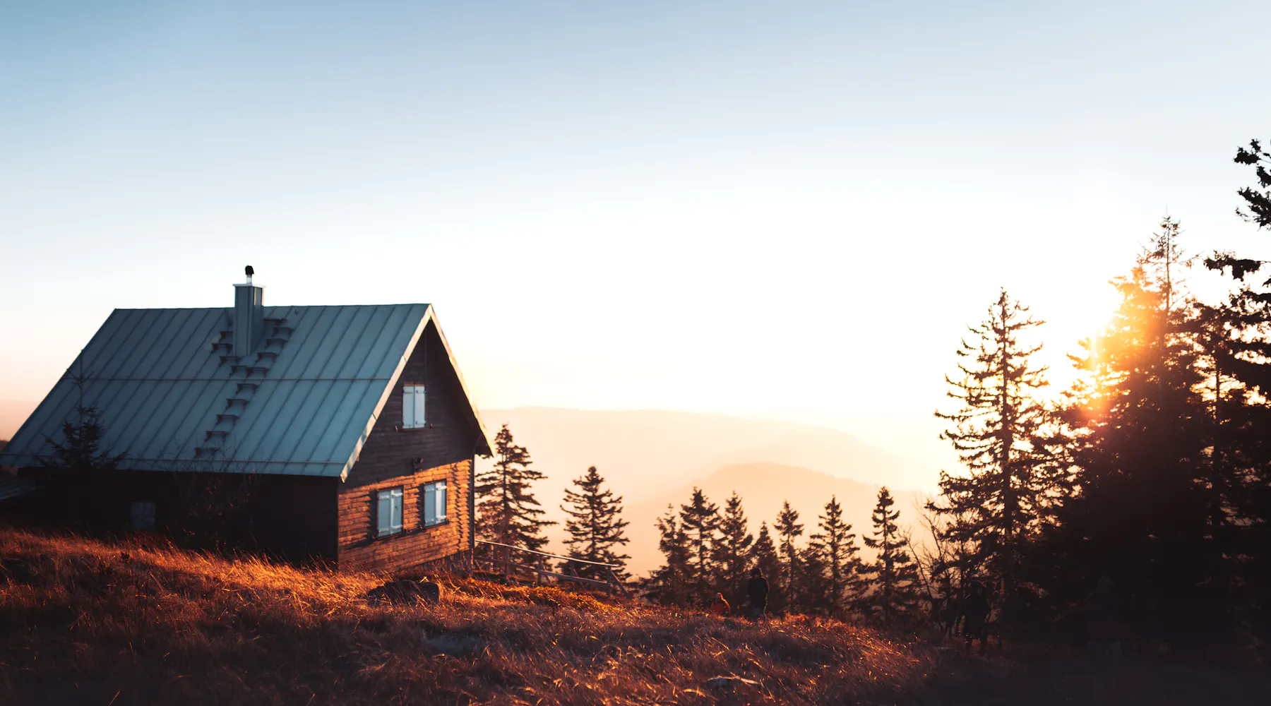 Rural cabin on a hillside at sunset