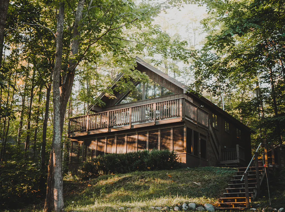 Timber home with large elevated deck among trees