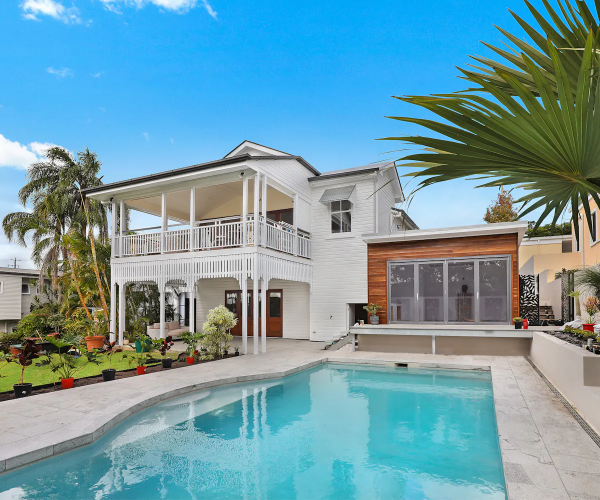 Two-storey Queenslander-style home with verandahs and pool